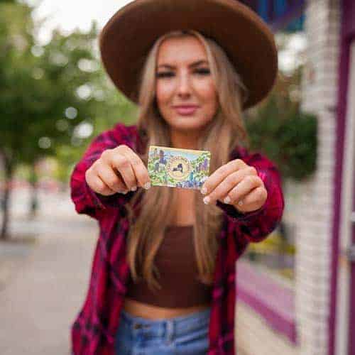 Woman holding Eat Local New York card