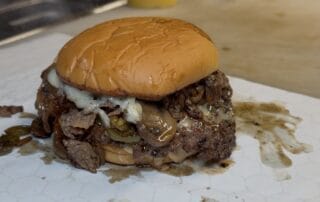 Cheesesteak smash burger oozing with juices and cheese