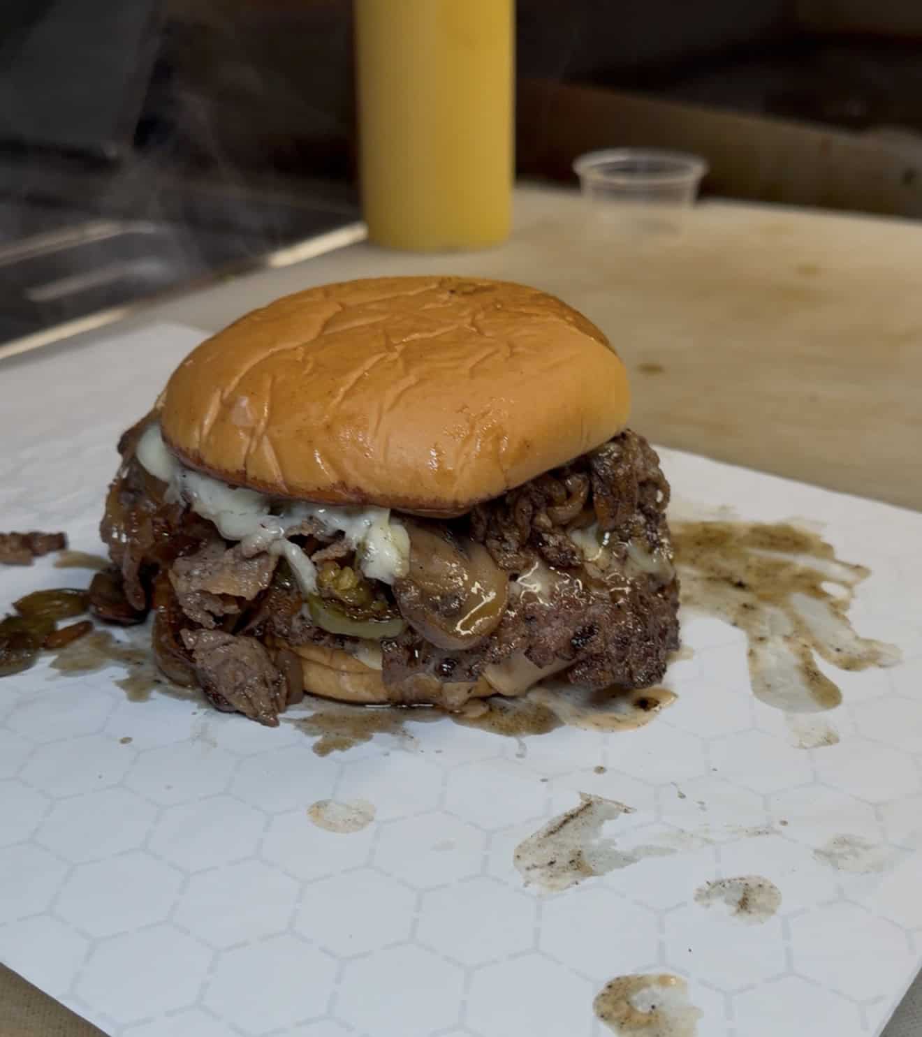Cheesesteak smash burger oozing with juices and cheese
